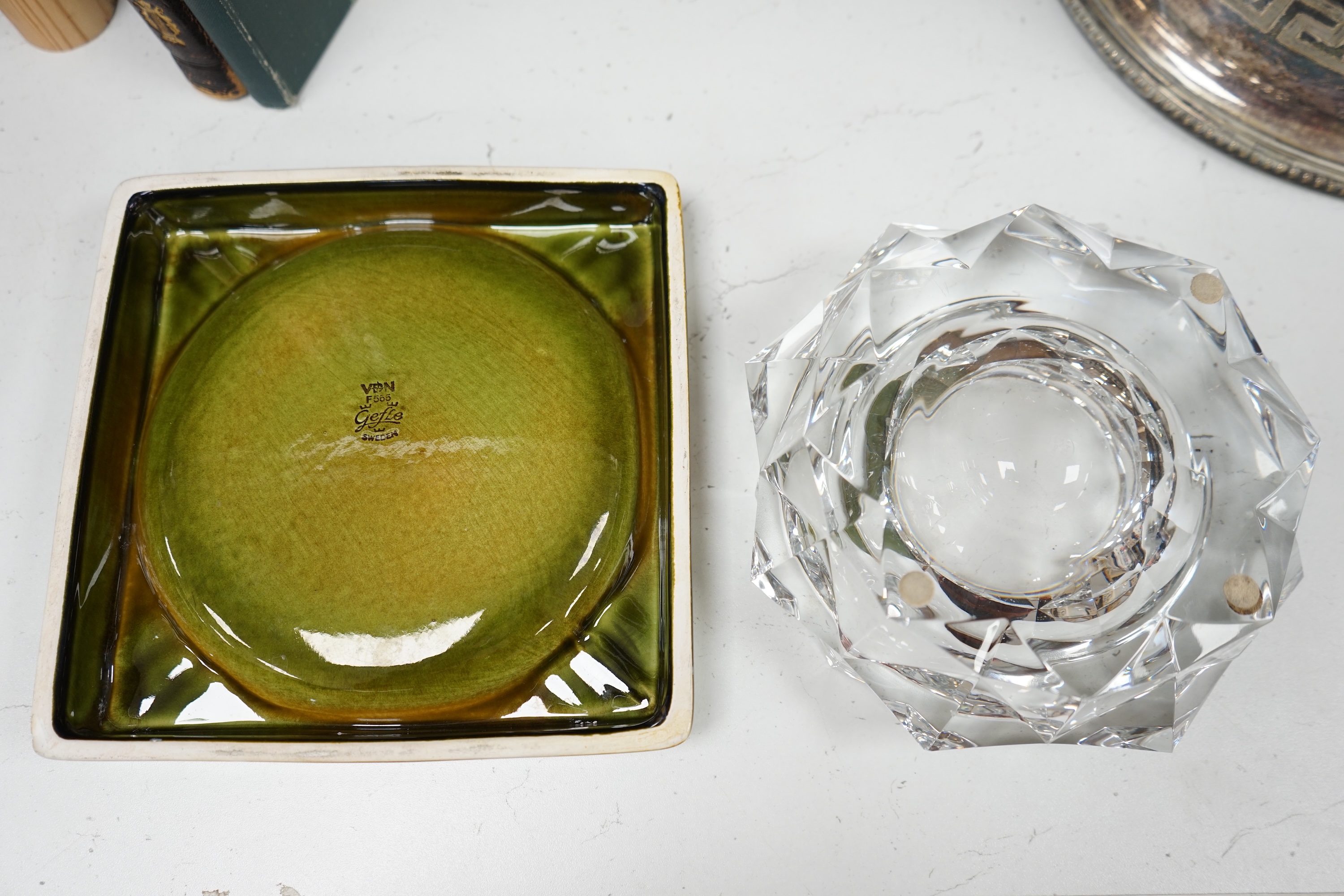 A Baccarat cut glass ashtray, 19cm diameter, and a Gefle Swedish green pottery ashtray, 20cm wide. Condition - good.